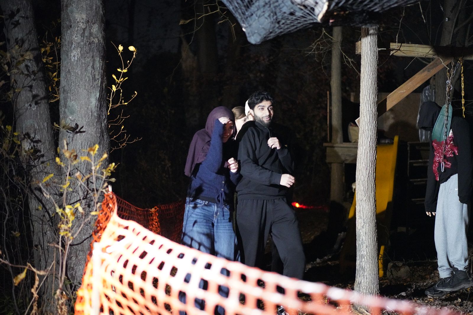 Guests huddled at the fence line, one shielding her face